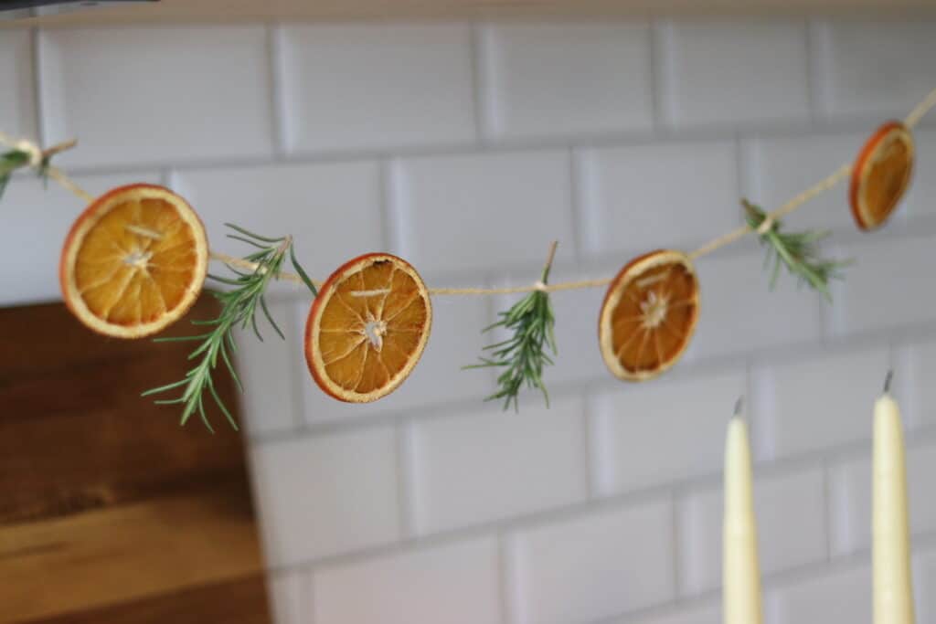 orange garland with beeswax candles