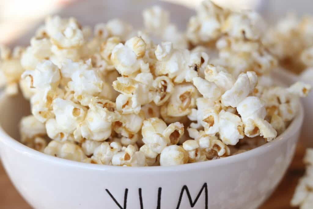 caramel corn in bowl on board