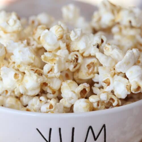 caramel corn in bowl on board