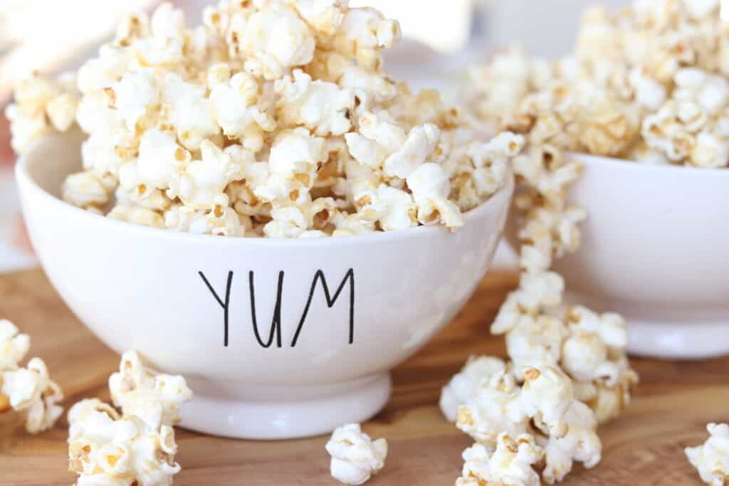 caramel corn recipe without corn syrup in white bowl on cutting board